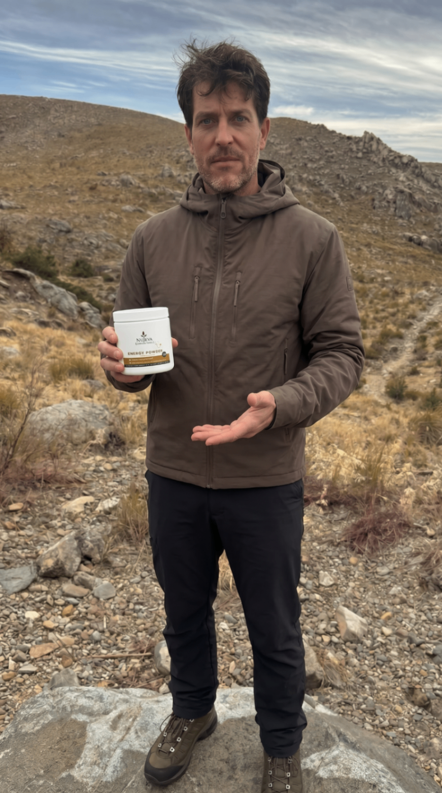 Man in mountains holding Nūjeva Energy Powder